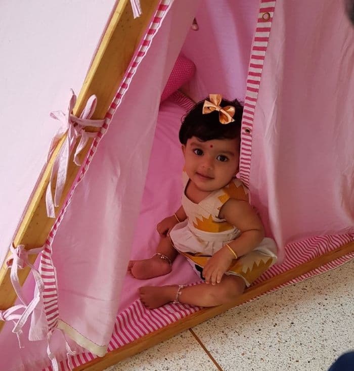 little girl sitting in a pink A-Shape kids tent