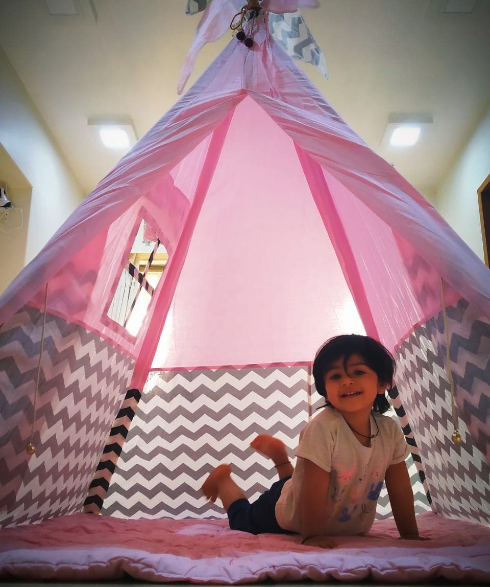 Pink Teepee Tent house with a girl playing in it