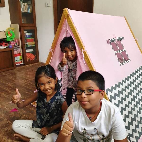 Kids enjoying fun indoor activities at home with a children's play tent