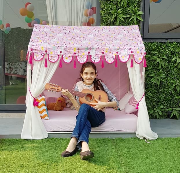 a 10 year old girl enjoying her pink unicorn play tent